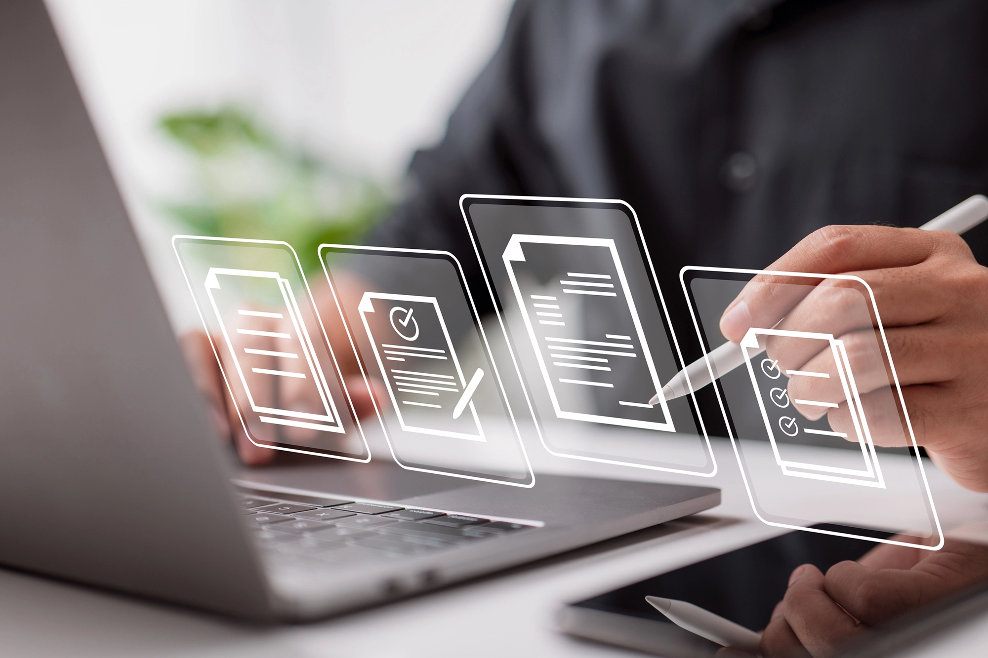 Close-up of hands and desktop with icons superimposed in the foreground, University of Connecticut Supply Chain Management